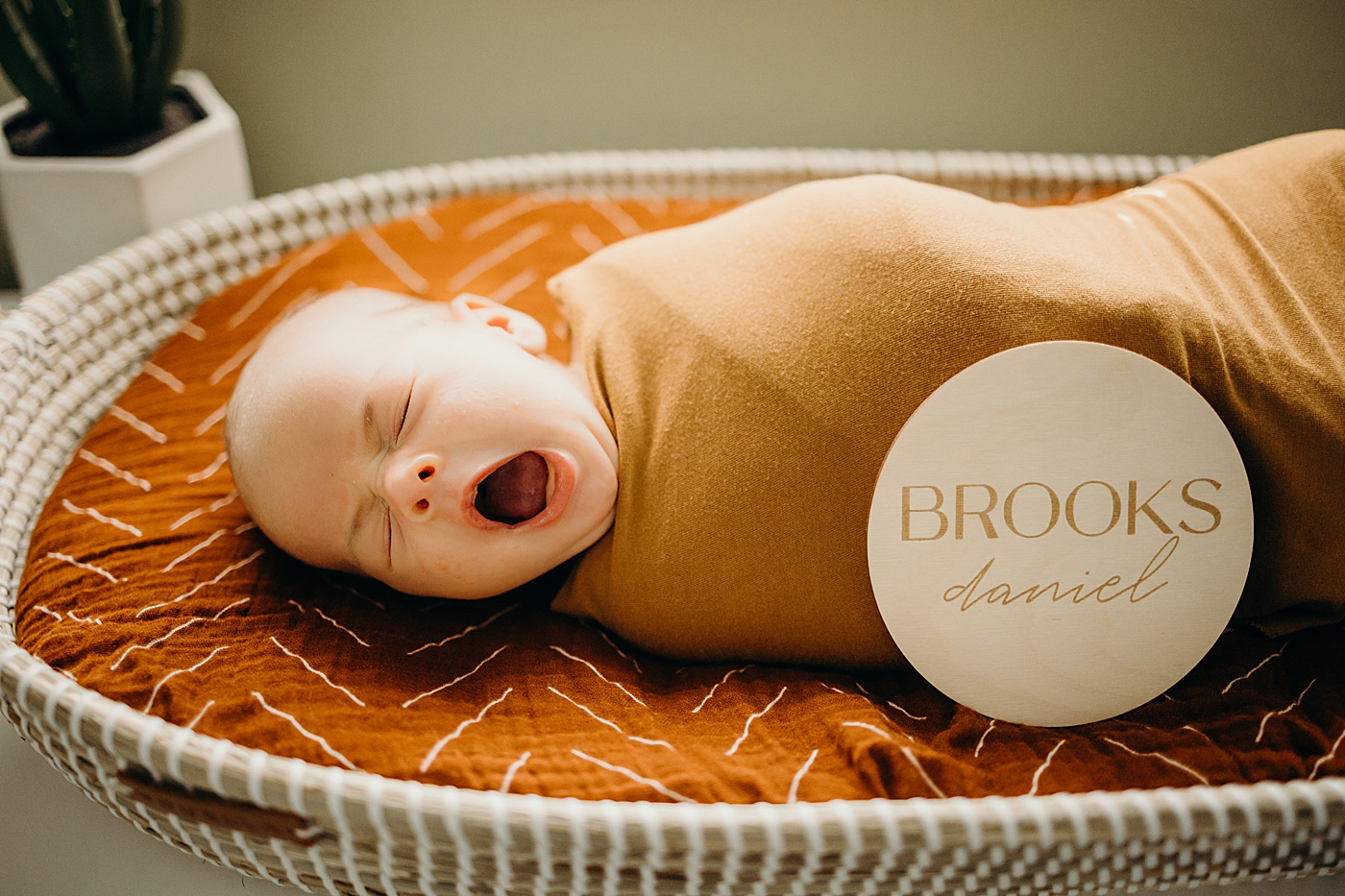 Baby yawning wrapped in swaddle yawning South Florida Newborn Photography captured by South Florida Family Photographer Maggie Alvarez Photography