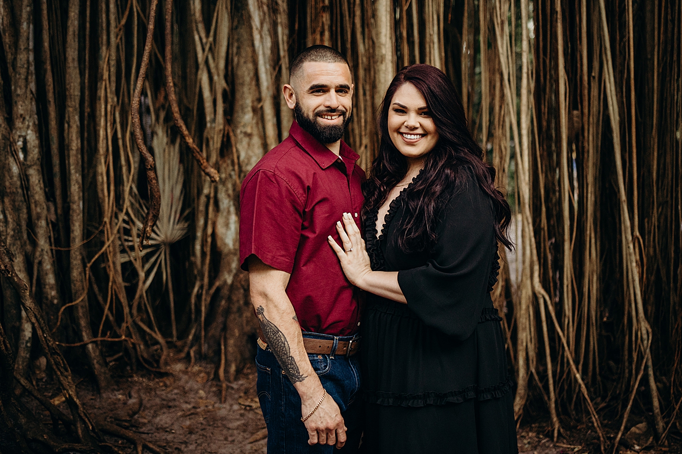 Couple holding each other with banyan tree behind them Tree Top Park Engagement Photography captured by Maggie Alvarez Photography