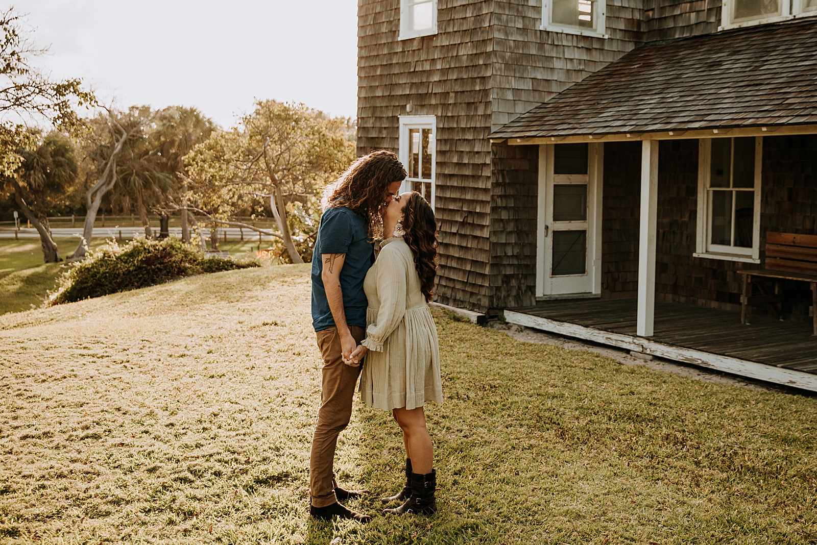 Couple kissing in front of classic home Dubois Park Engagement Photography captured by South Florida Family Photographer Maggie Alvarez Photography
