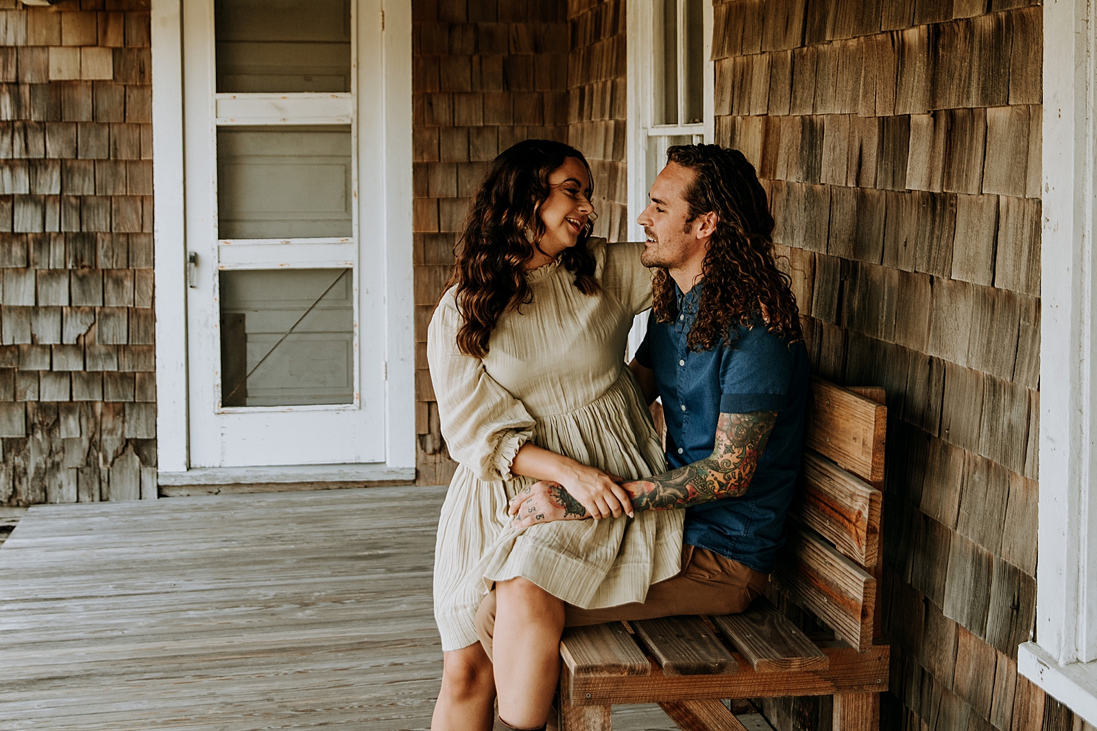 Lady sitting on man's lap with both of them looking at each other Dubois Park Engagement Photography captured by South Florida Family Photographer Maggie Alvarez Photography