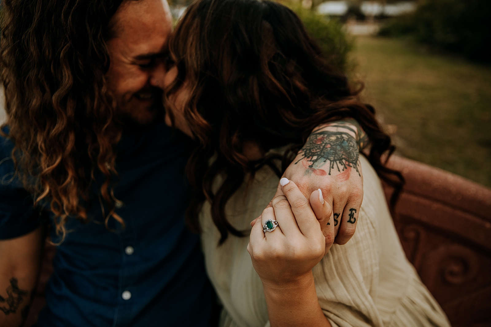 Couple nuzzling and holding hands showing off emerald engagement ring Dubois Park Engagement Photography captured by South Florida Family Photographer Maggie Alvarez Photography