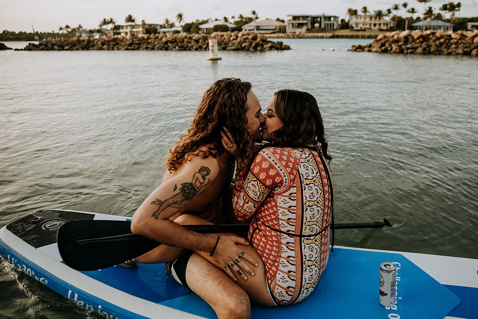 Couple kissing on canoe on calm water Dubois Park Engagement Photography captured by South Florida Family Photographer Maggie Alvarez Photography