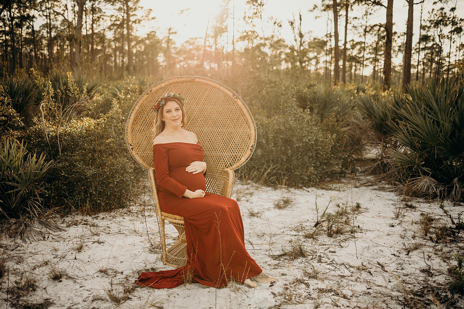 Pregnant woman sitting on chair on the sand Johnathan Dickinson Park Maternity Photography captured by South Florida Family Photographer Maggie Alvarez Photography