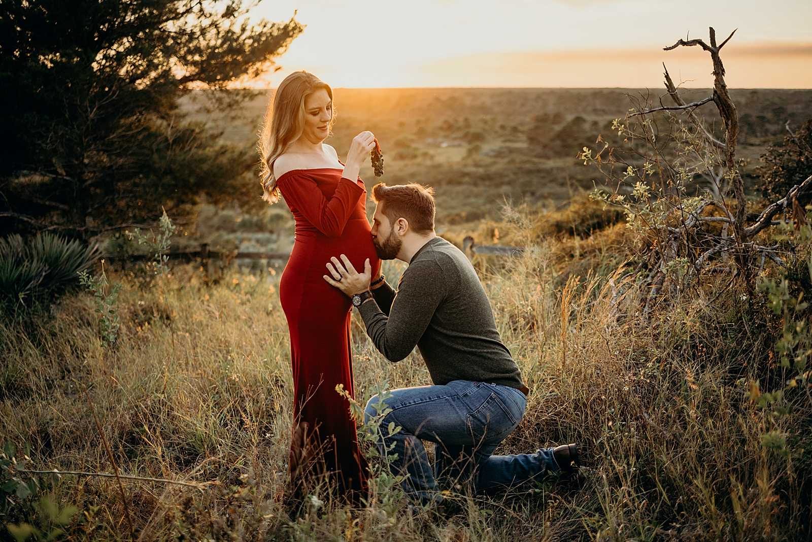 Man kissing his wife's pregnant stomach Johnathan Dickinson Park Maternity Photography captured by South Florida Family Photographer Maggie Alvarez Photography