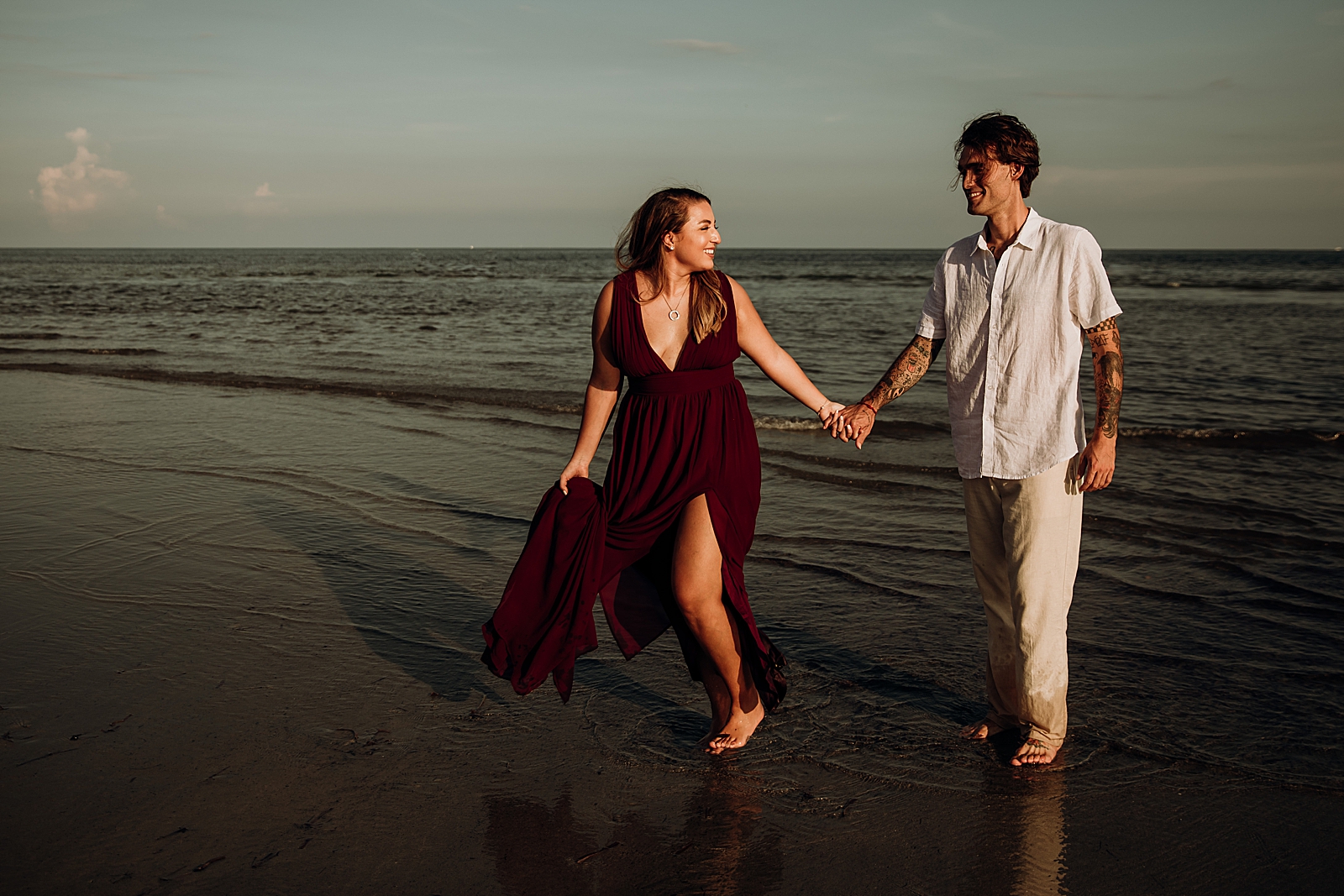Couple walking together on wet sand Key Biscayne Beach Engagement Photography captured by South Florida Family Photographer Maggie Alvarez Photography