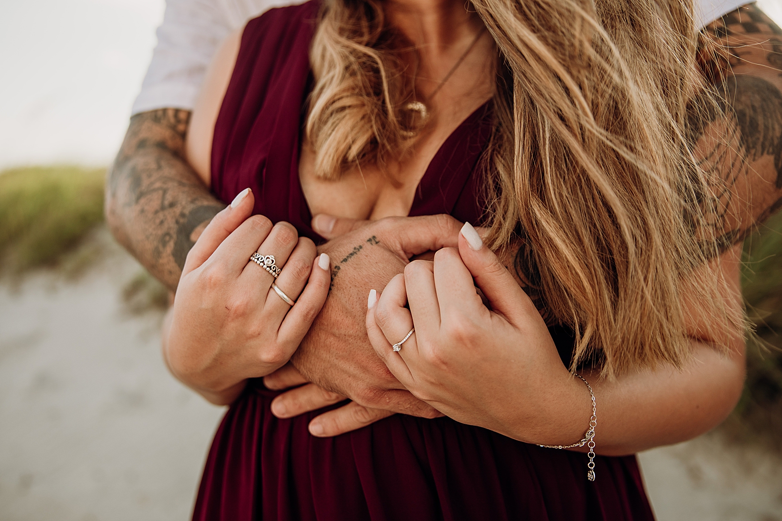 Closeup of man wrapping arms around lady wearing pandora princess ring and engagement ring Key Biscayne Beach Engagement Photography captured by South Florida Family Photographer Maggie Alvarez Photography