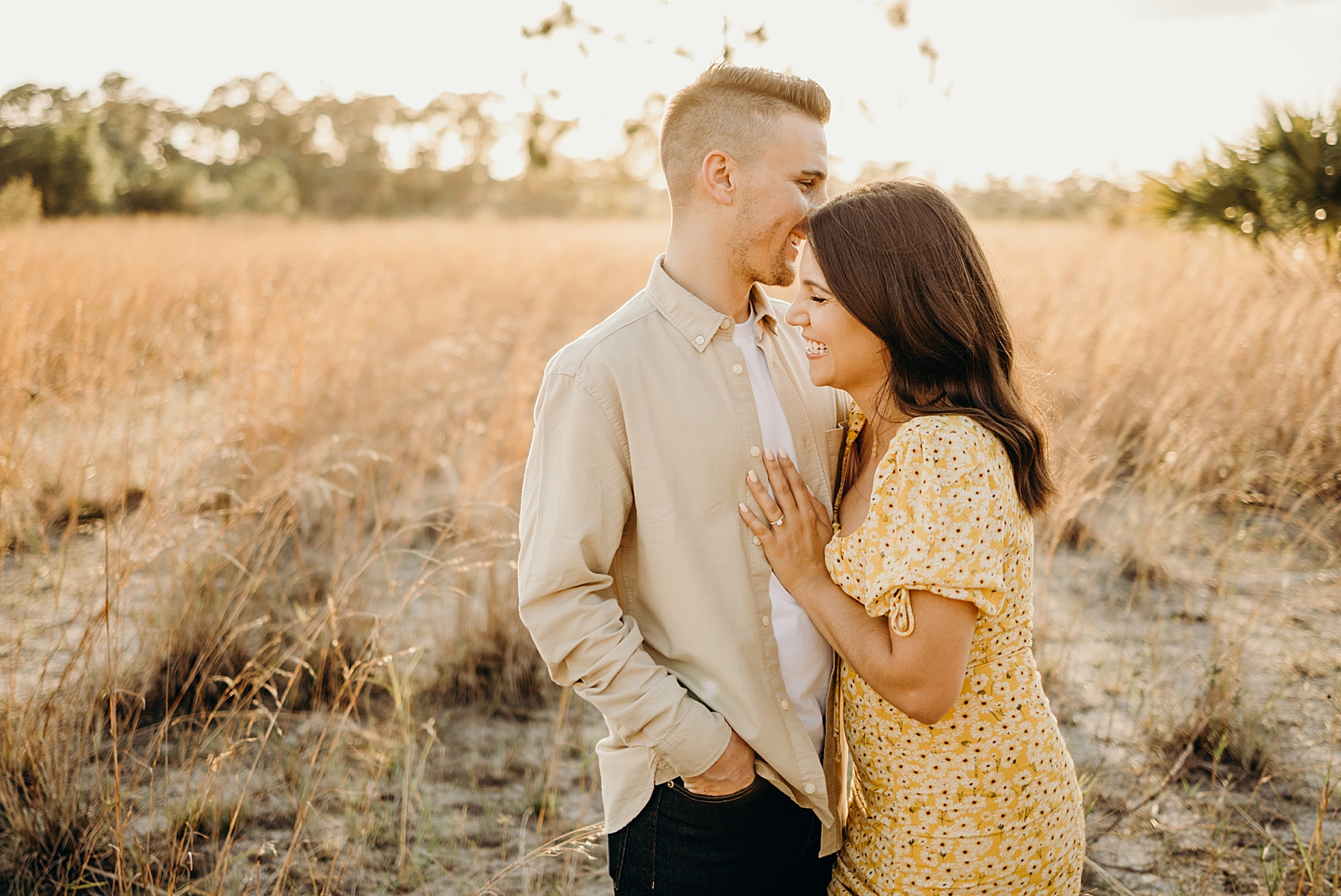 Couple holding each other and smiling Royal Palm Nature Preserve Engagement Photography captured by South Florida Engagement Photographer Maggie Alvarez Photography