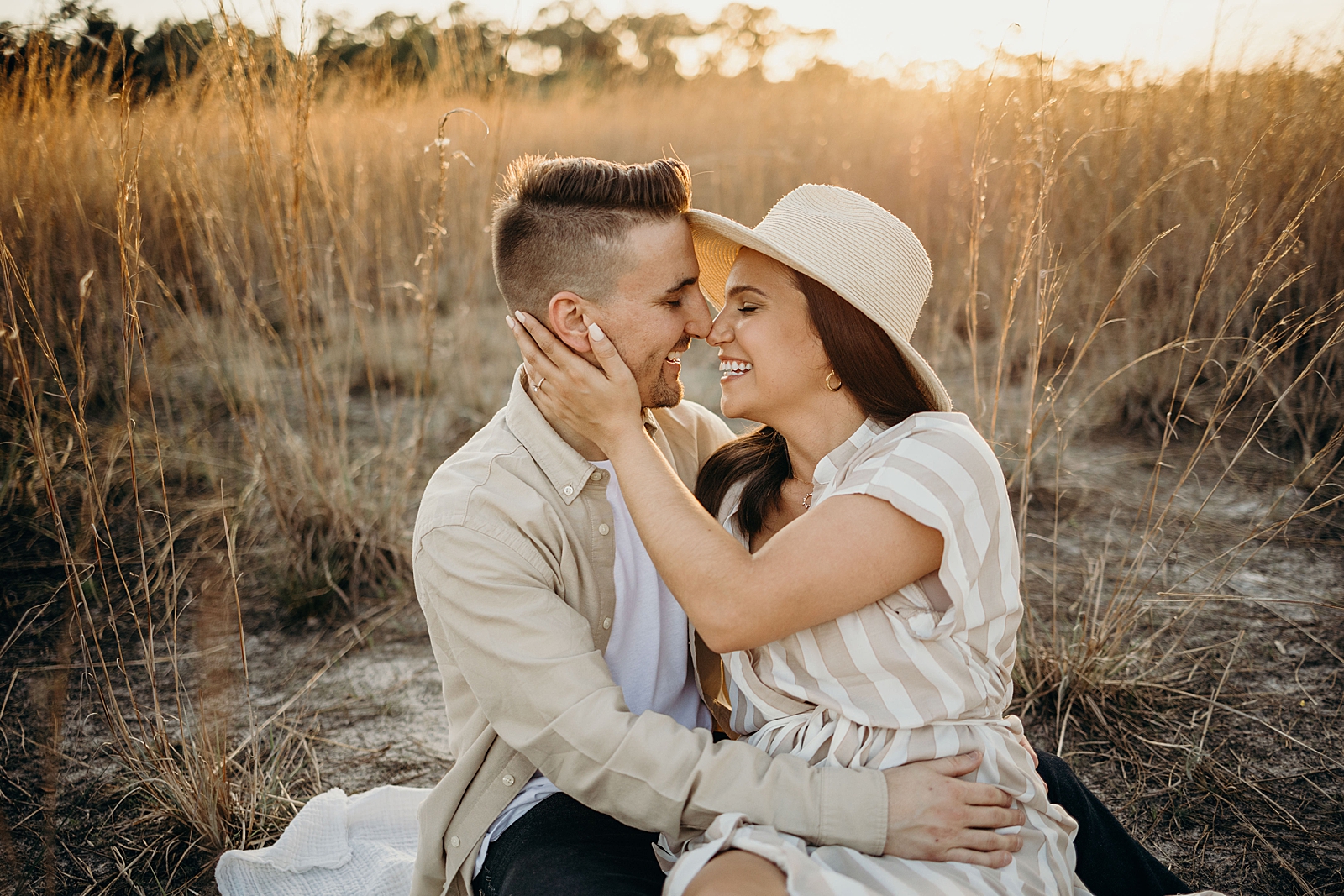 Couple sitting and nuzzling their noses Royal Palm Nature Preserve Engagement Photography captured by South Florida Engagement Photographer Maggie Alvarez Photography