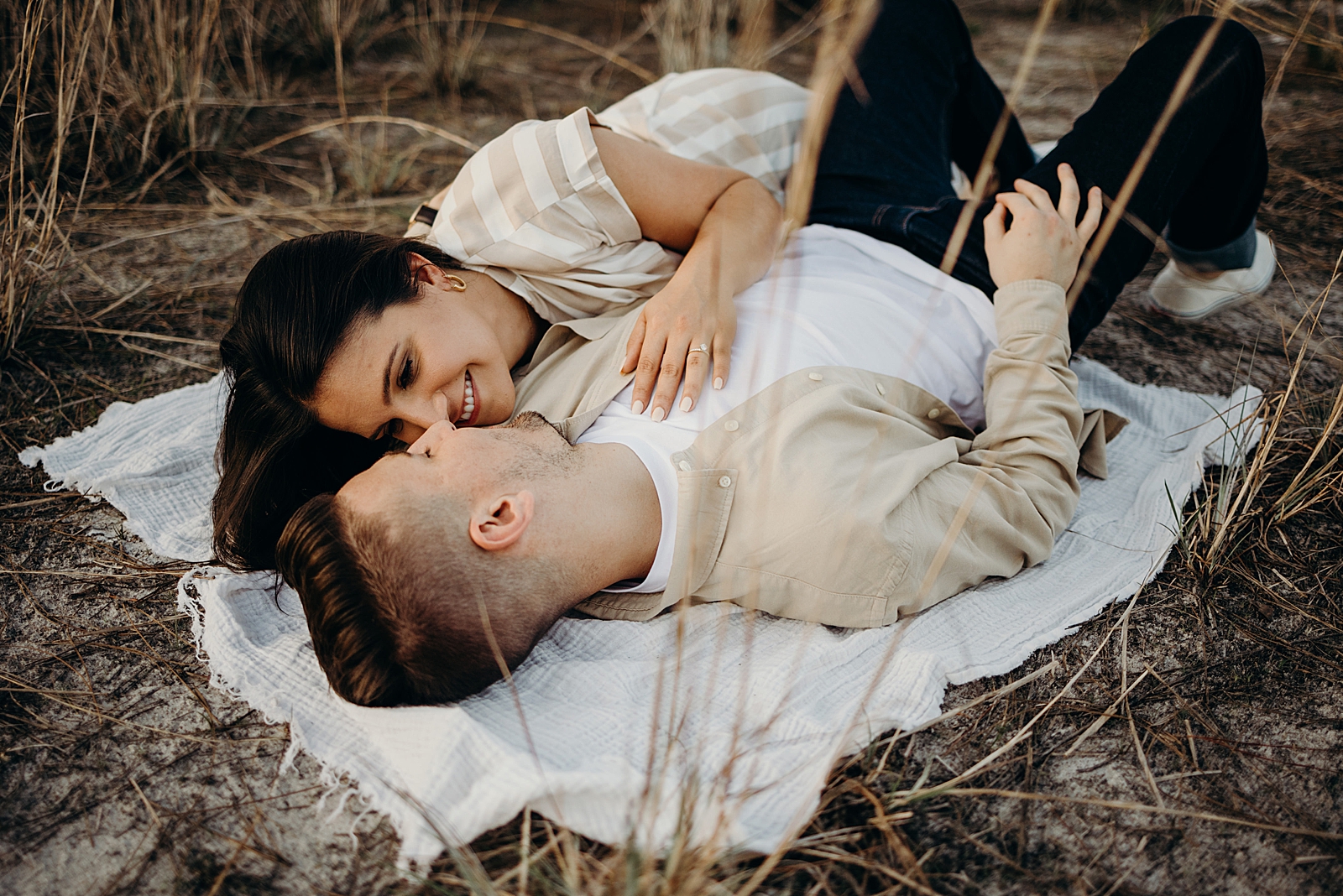 Woman laying on man's should on the ground Royal Palm Nature Preserve Engagement Photography captured by South Florida Engagement Photographer Maggie Alvarez Photography