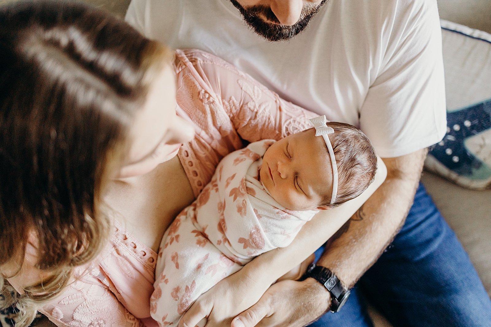 Overhead shot of mother holding baby with dad holding his wife South Florida Newborn Photography Photography captured by South Florida Family Photographer Maggie Alvarez Photography