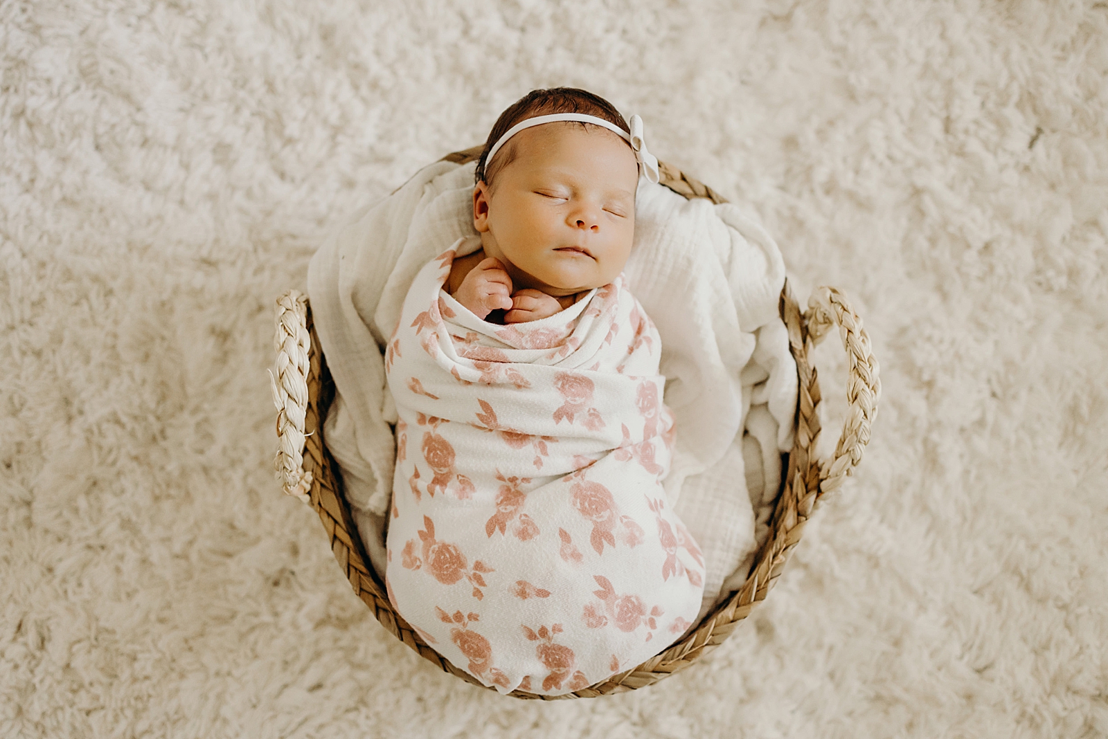 Baby wrapped in floral blanket resting in basket South Florida Newborn Photography Photography captured by South Florida Family Photographer Maggie Alvarez Photography