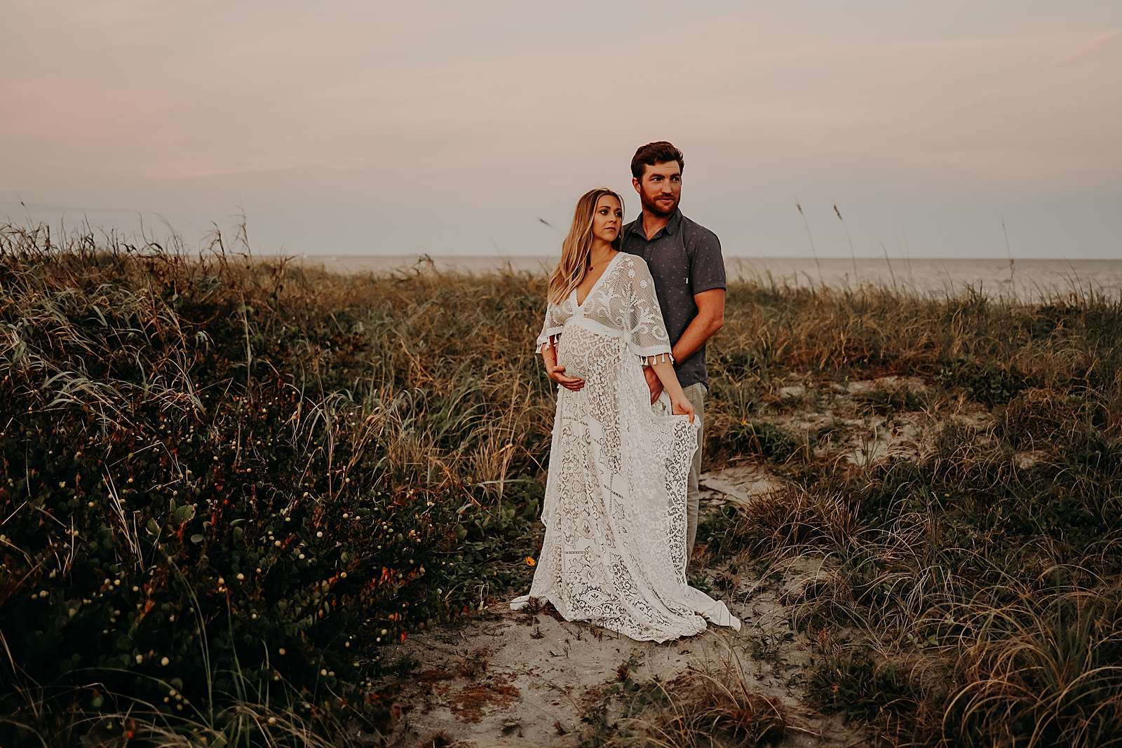 Pregnant couple posing on sunset beach Spanish River Park Maternity Photography captured by South Florida Family Photographer Maggie Alvarez Photography
