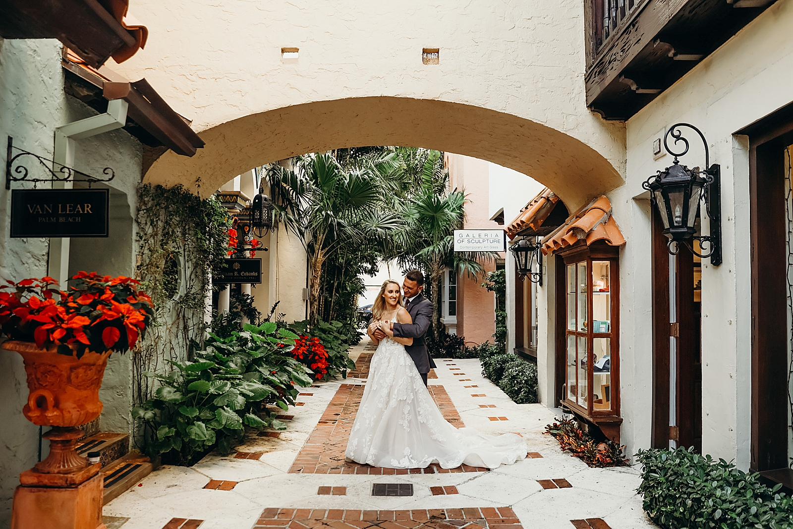 Man hugging lady from behind in wide shot Worth Avenue Bridal Photography captured by South Florida Engagement Photographer Maggie Alvarez Photography