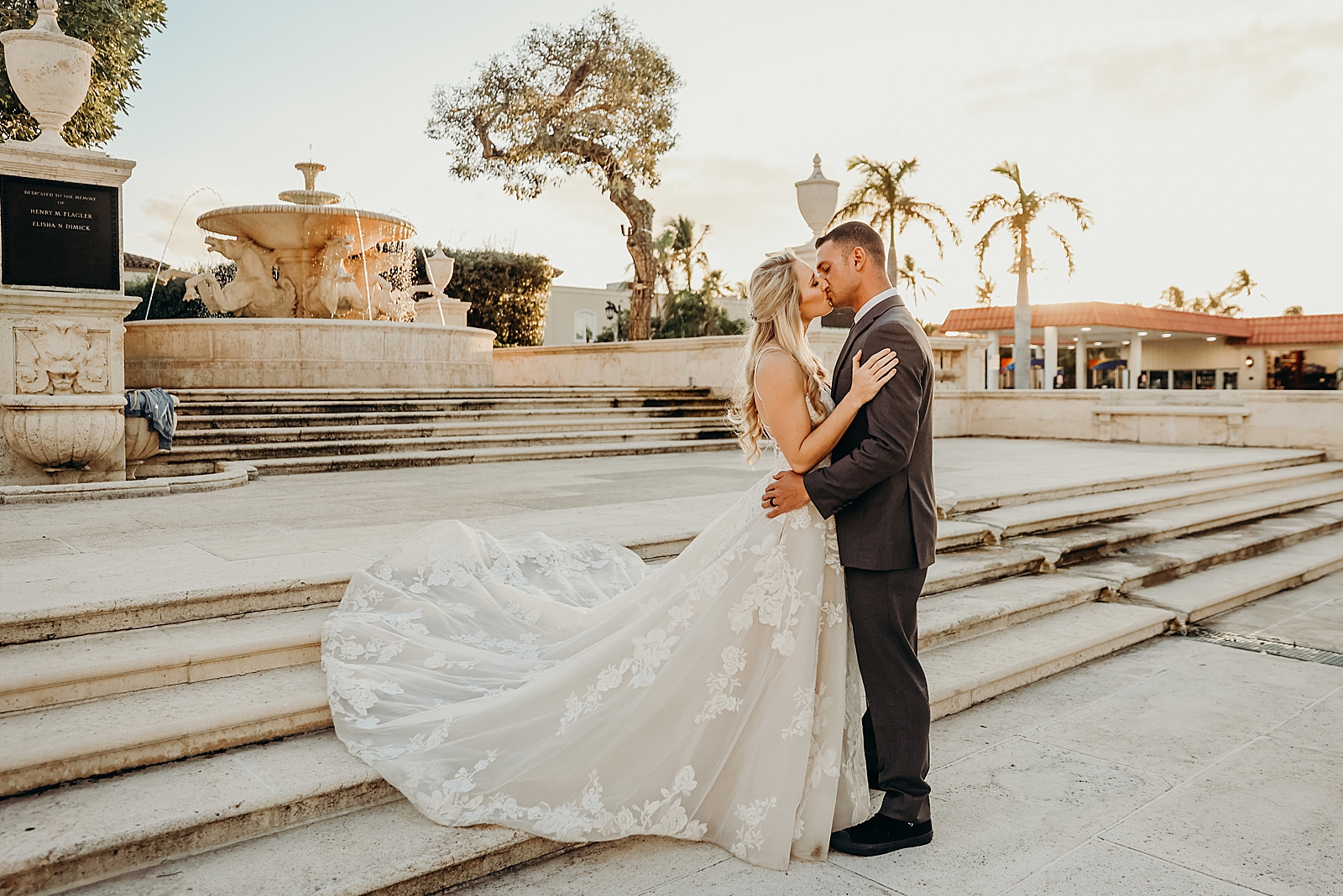 Couple kissing and holding each other by the fountain Worth Avenue Bridal Photography captured by South Florida Engagement Photographer Maggie Alvarez Photography