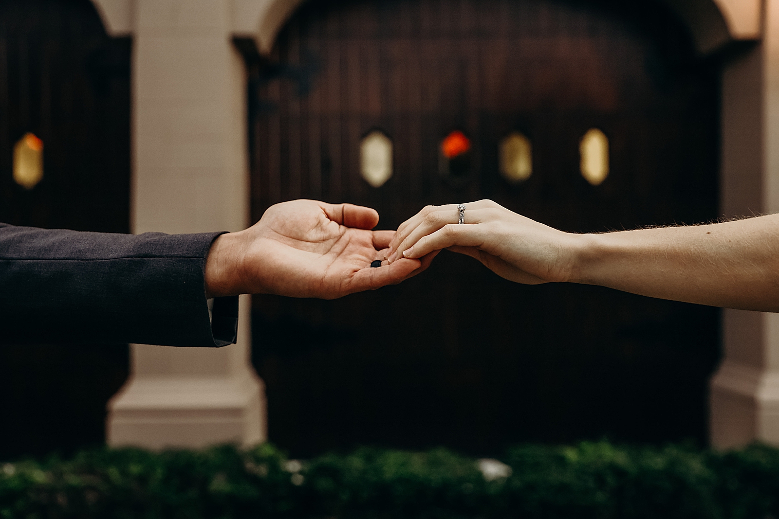 Couple extending arms to each other and slightly holding hands Worth Avenue Bridal Photography captured by South Florida Engagement Photographer Maggie Alvarez Photography