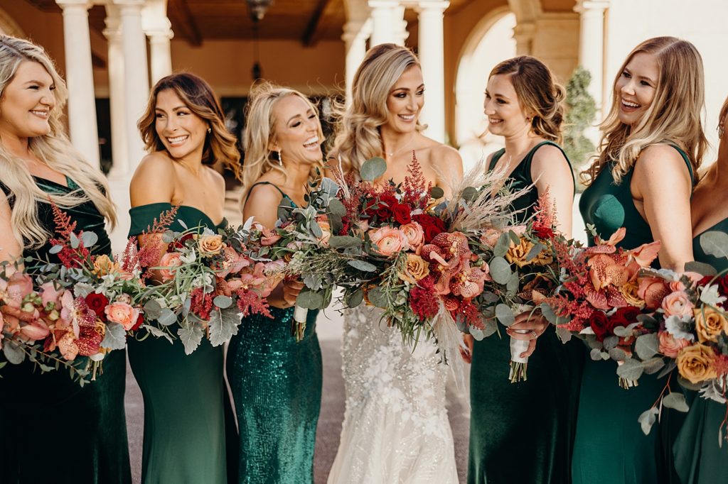 Bride with Bridesmaids laughing with bouquets