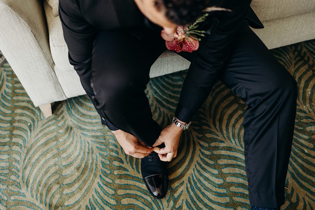 Groom getting ready tying his shoes