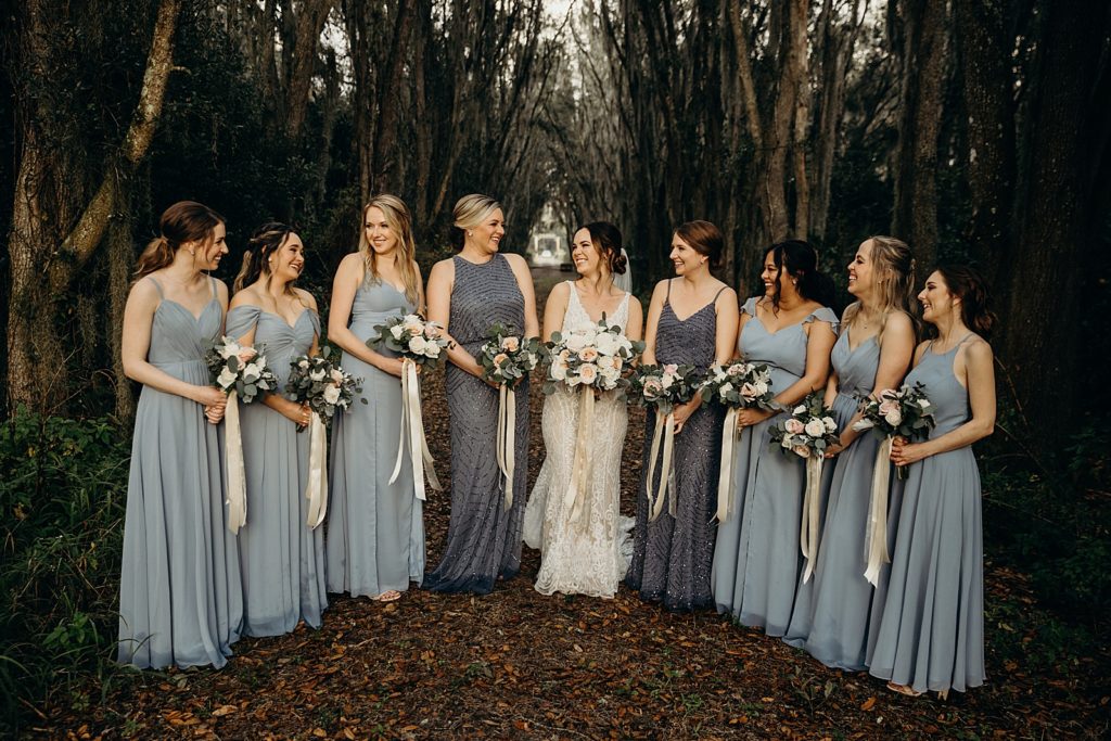 Bride and Bridesmaids holding bouquets in the forest
