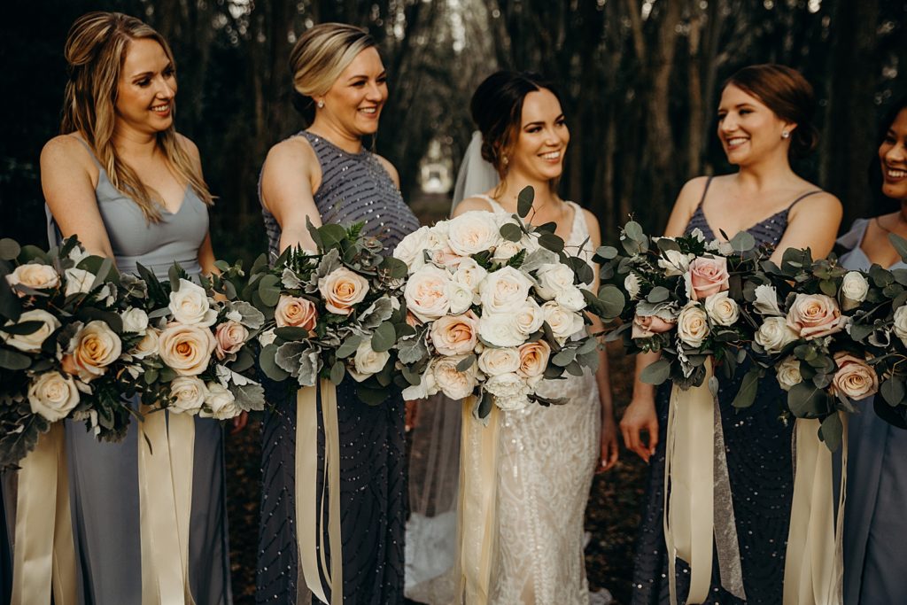 Bride and Bridesmaids holding their bouquets out