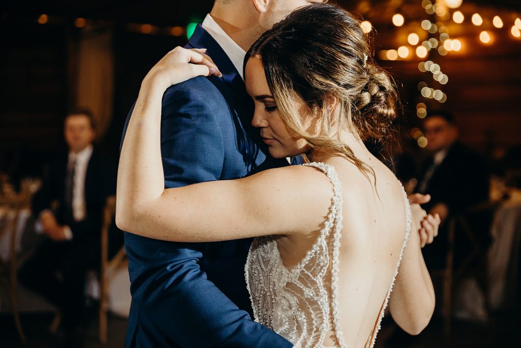 Bride resting her head on Groom during First Dance
