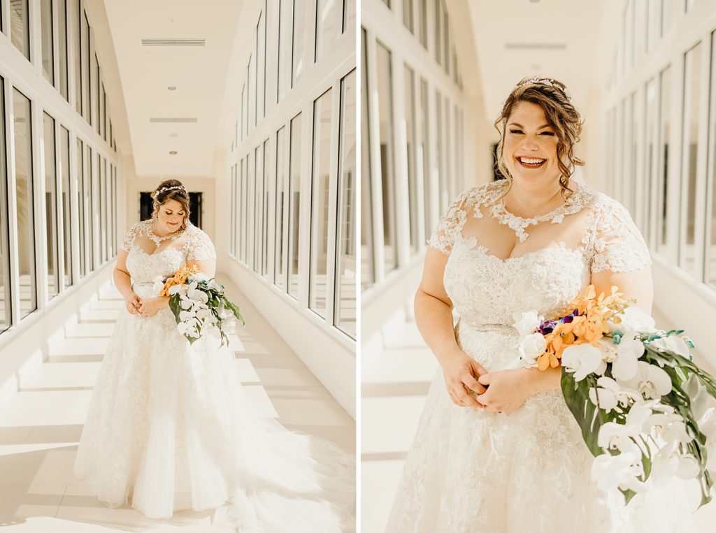 Bride posing with tropical bouquet in window hallway