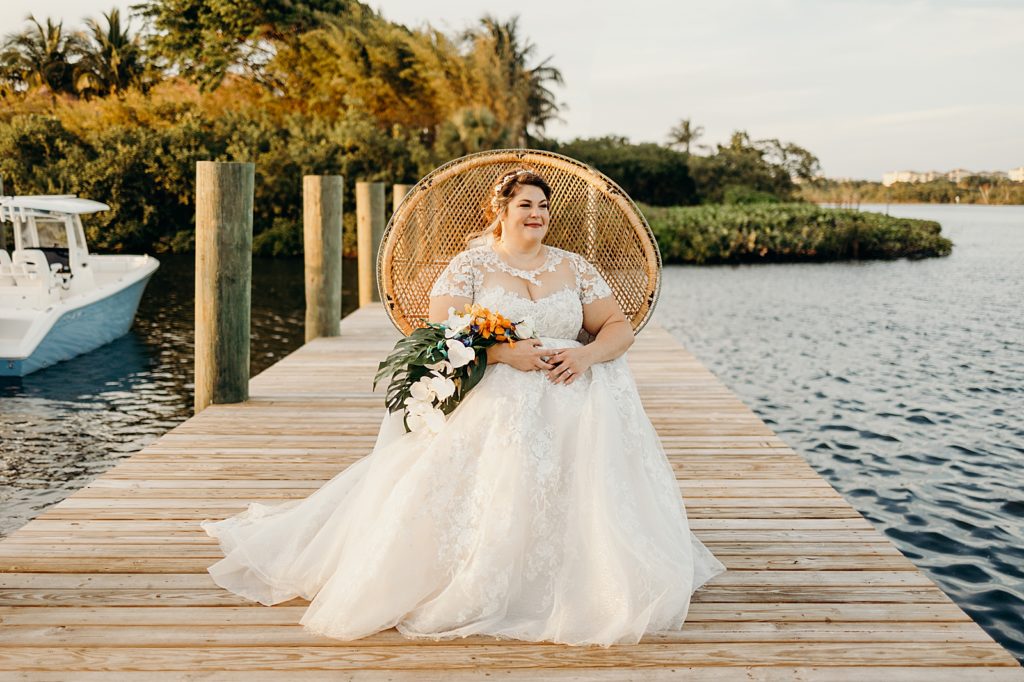 Bride sitting on the dock with tropical bouquet