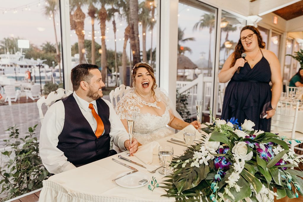 Bride and Groom laughing during Maid of Honor speech