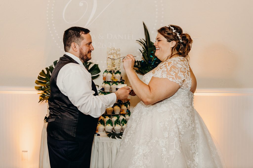 Bride and Groom exchanging cake bites