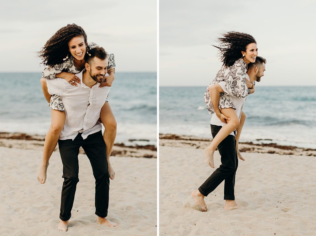 Woman piggy backing on man on the beach in front of the ocean