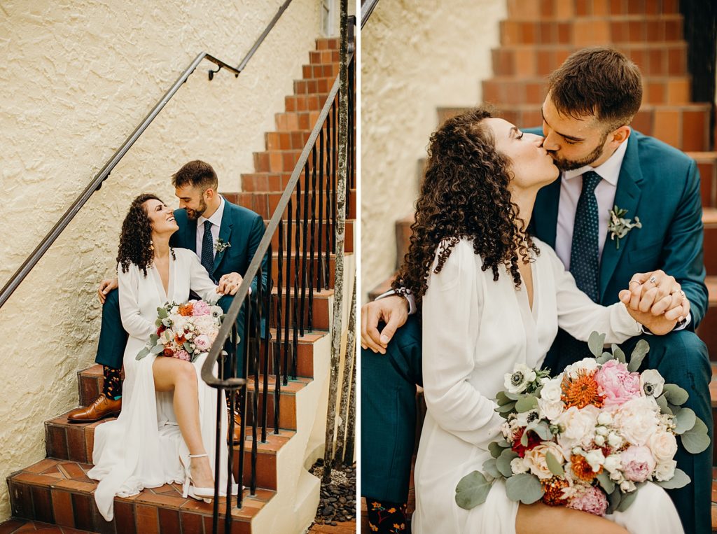 Couple sitting together on staircase and kissing with beautiful bouquet