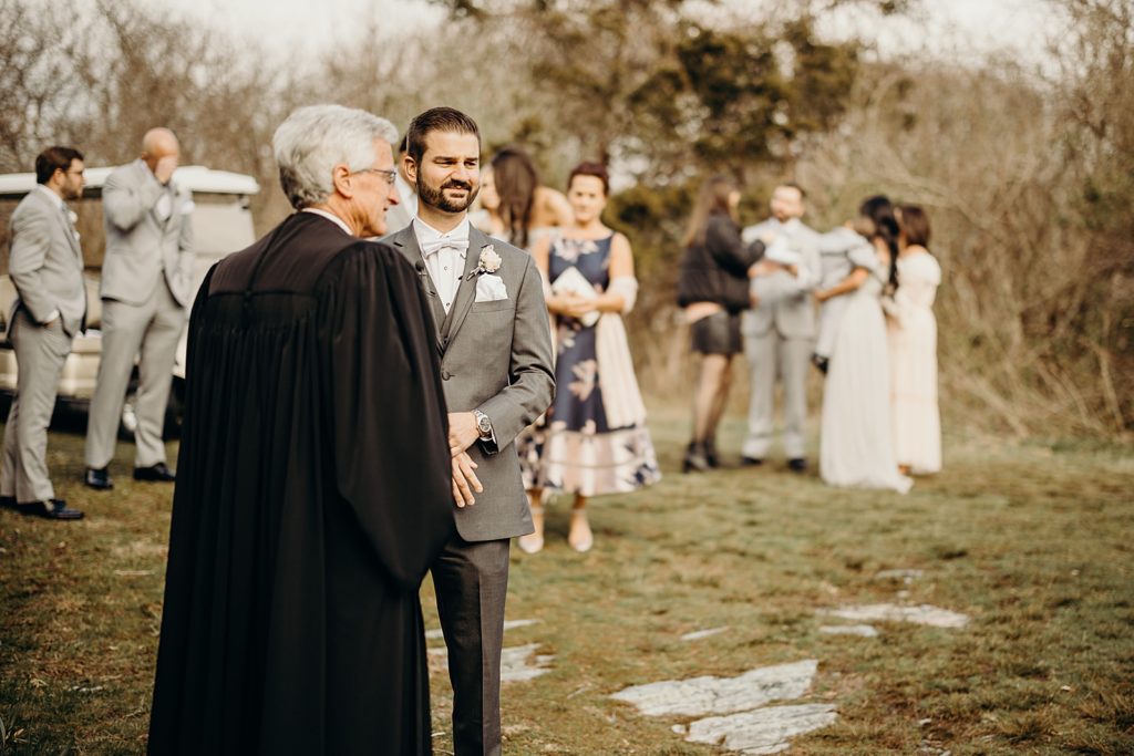 Groom standing with Officiant awaiting for Ceremony to begin