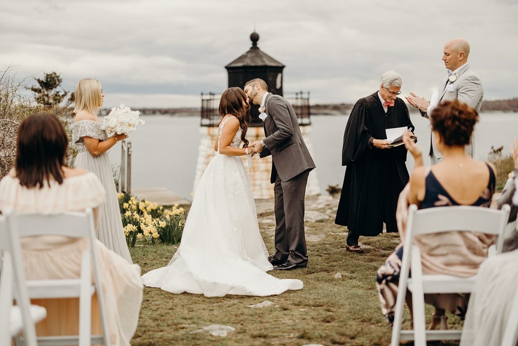 Just married Bride and Groom kissing for outdoor Ceremony