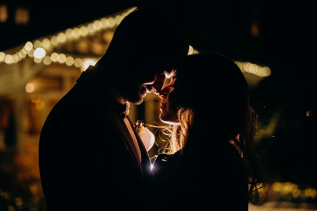 Nighttime silhouette of Bride and Groom touching their noses