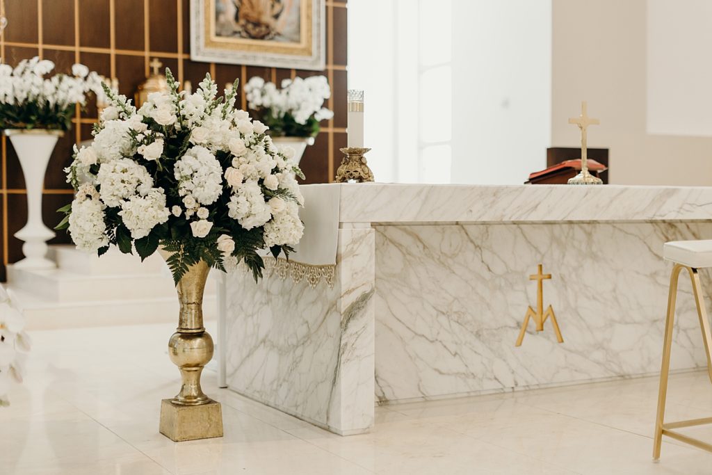 Detail shot of religious alter place with white flower decor