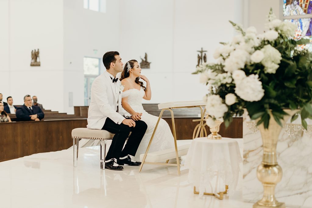 Bride and Groom sitting during indoor Homily Ceremony