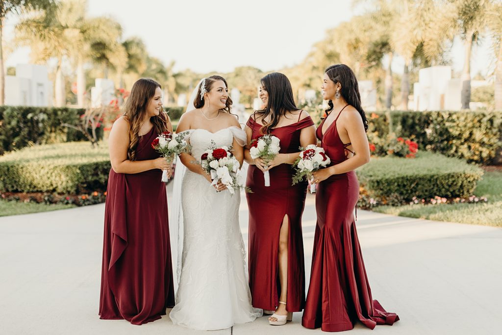 Bride holding bouquet with Bridesmaids