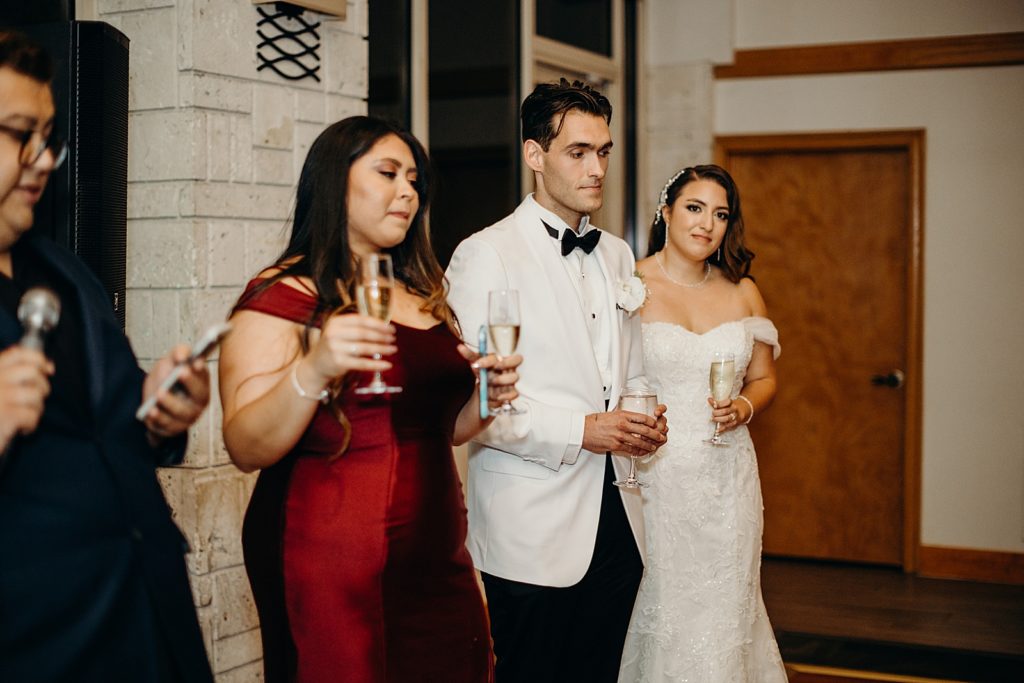Bride and Groom holding glasses of Champaign