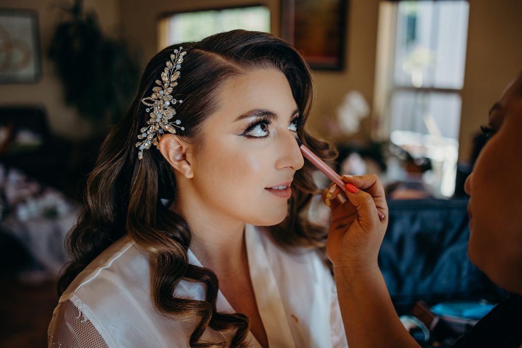 Bride getting makeup done getting ready