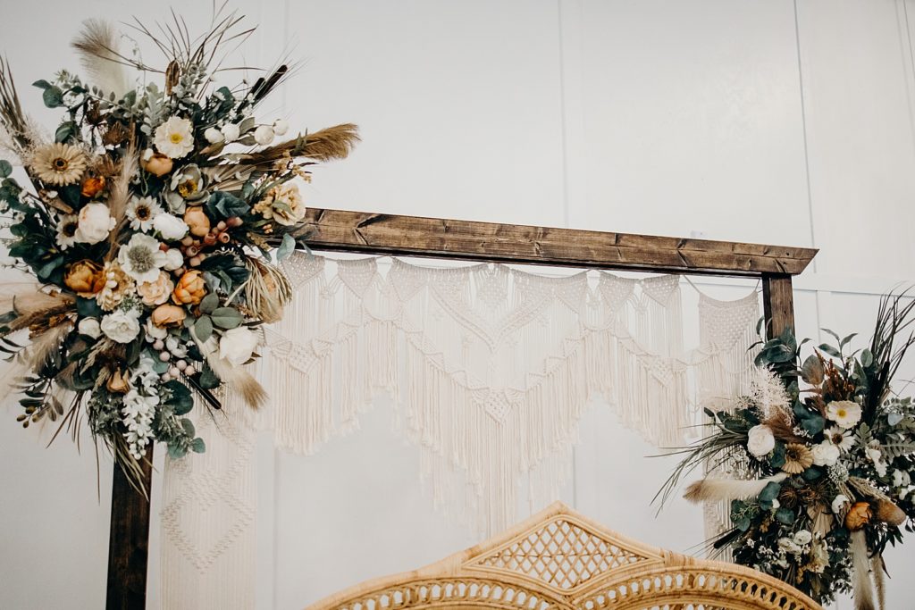Detail shot of arch with flowers over sweetheart table