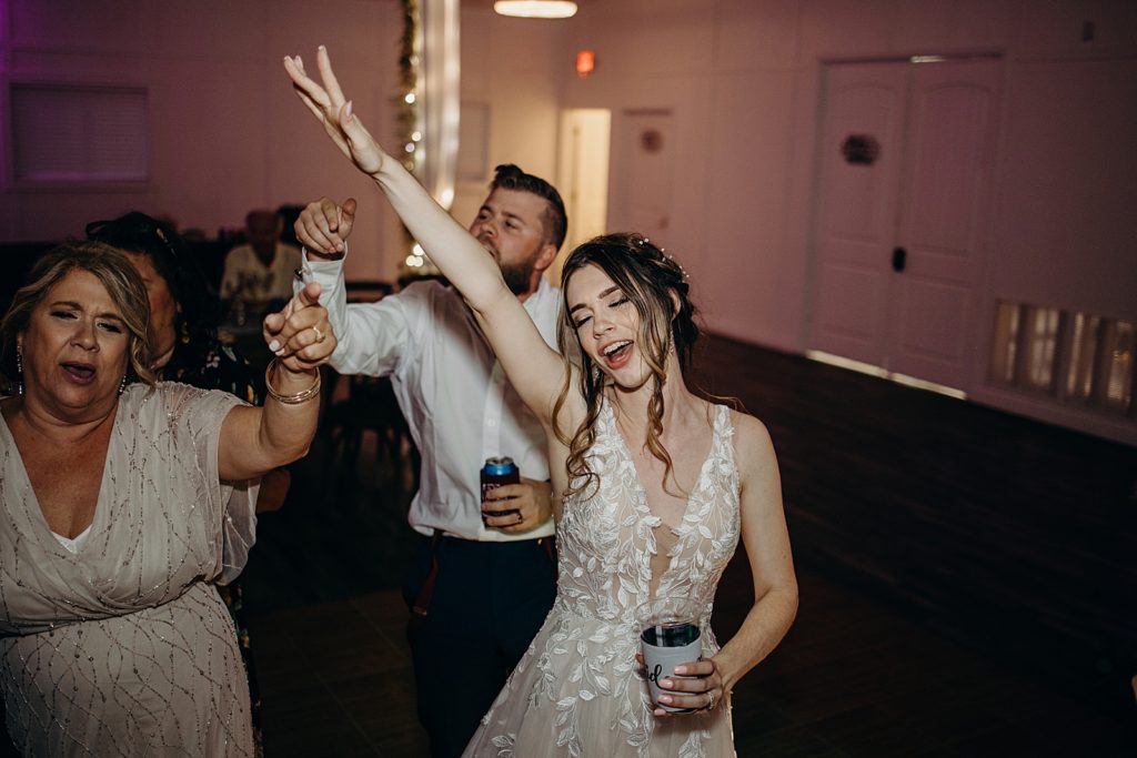 Bride and Groom dancing at the Reception with drinks in hand