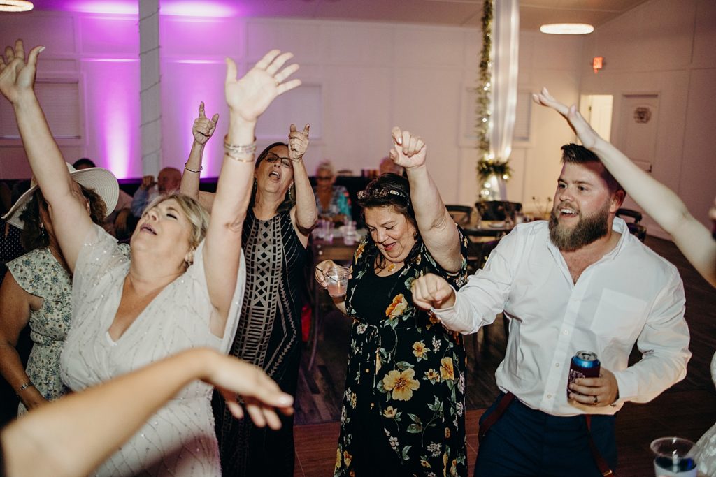 Groom dancing with guests at Reception