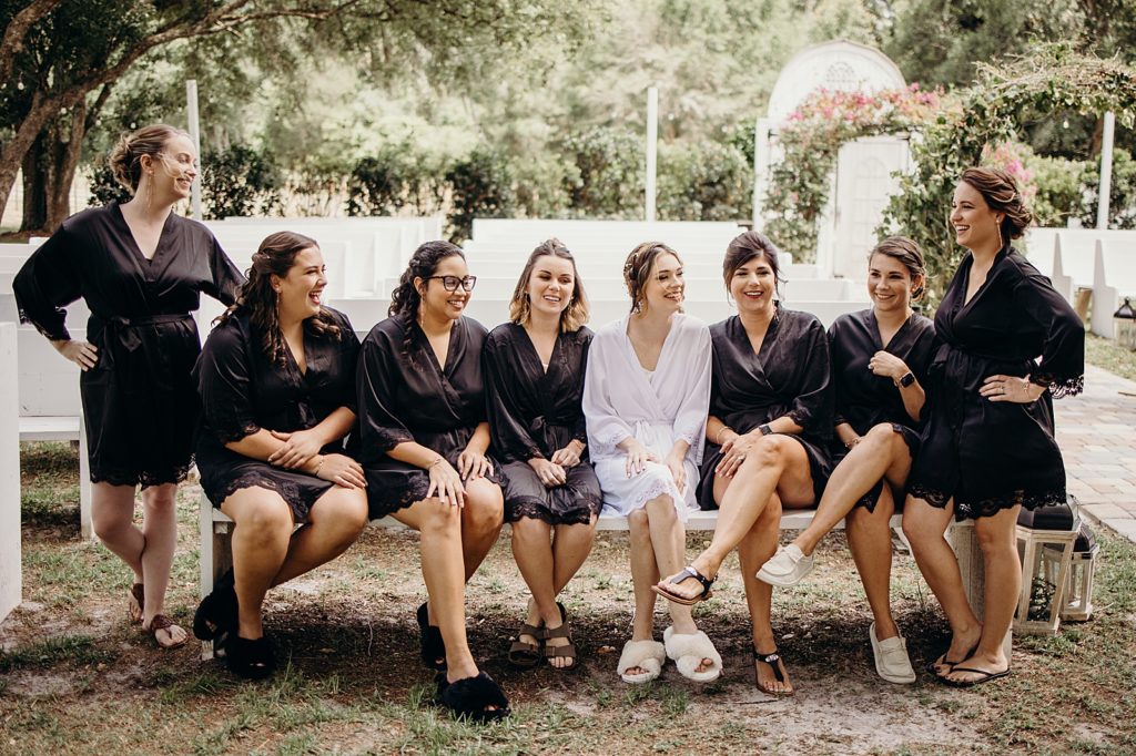 Bride and Bridesmaids sitting out in Ceremony area after getting hair done