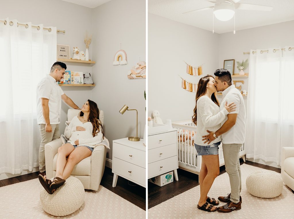 Pregnant woman sitting in white chair in baby room with man standing next to her looking at her