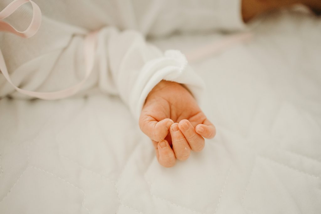 Closeup of infant had clutched as Baby sleeps