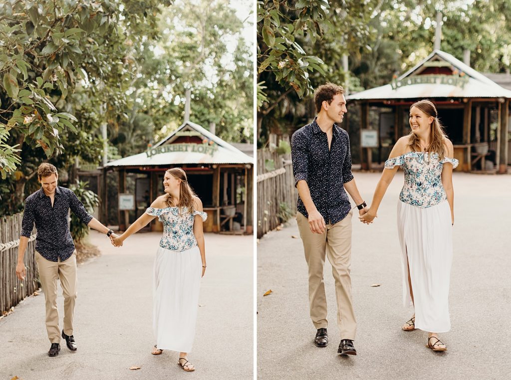 Couple holding hands and walking in zoo together
