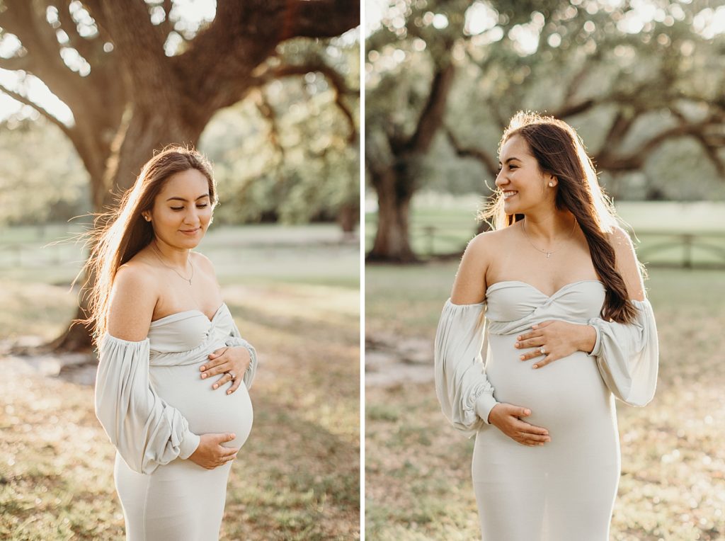 Portraits of pregnant woman holding baby bump out of grassy field